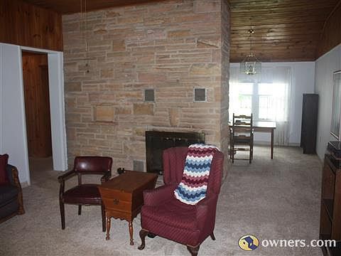 Floor to ceiling stone fireplace provides warmth in winter.