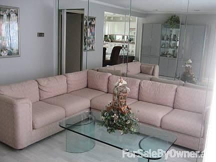 Living Room : Floors are Laminated and the Back Wall is Completely Mirrored