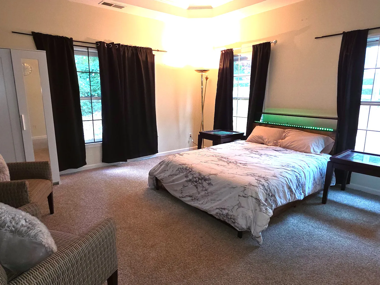 Fully furnished bed room with bed, mattress, walk in closet, extra cupboard, arm chairs, lamp, curtains, computer table/chair and ensuite full bath