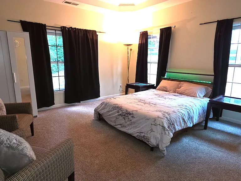Fully furnished bed room with bed, mattress, walk in closet, extra cupboard, arm chairs, lamp, curtains, computer table/chair and ensuite full bath