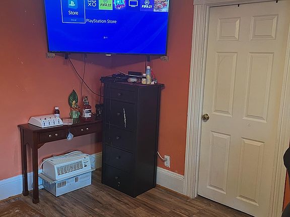 Living room leading to the door of secondary bedroom on main floor.