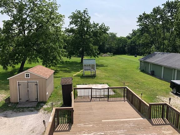 Backyard view from upstairs bedroom with French doors