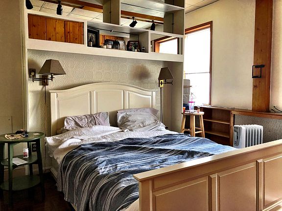 Bedroom (bed included) with lots of light and built ins for storage.