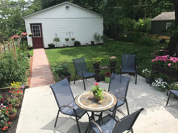back patio and brick paver pathway to garage