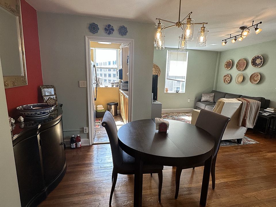 View of kitchen and living room from dining area. Newly waxed hardwood floors.