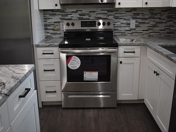 Fully updated Kitchen with island, granite countertops, New Cabinets and Backsplash. The home has New Stainless Steel Appliances and New Light Fixtures.