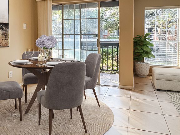 Virtually staged dining with access to patio with outdoor storage closet.
