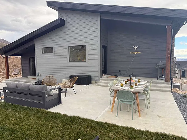 Patio with couches and patio table that seats 8. Also has a piped natural gas barbecue grill.