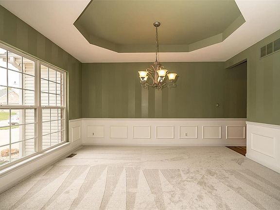 Formal Dining Room with Coffered Ceiling, New Carpet 10/18, Double Windows, and White Wainscoting all around.