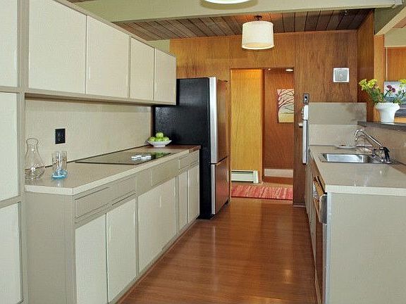 The kitchen cabinets have been refreshed with new paint.