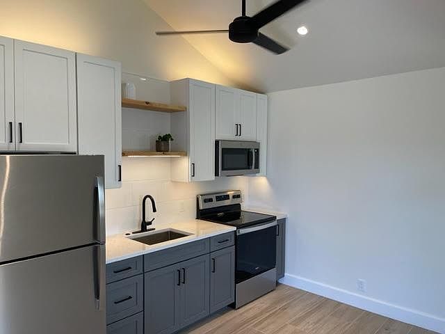 Full kitchen with new, full size stainless steel appliances; beautiful ceiling fan for warmer days