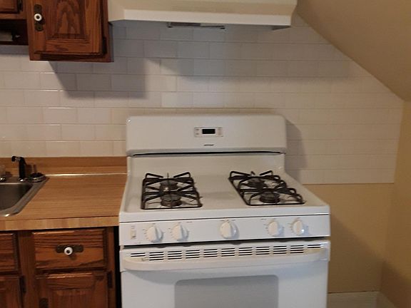 New stove, stove vent and brand new subway tile backsplash.