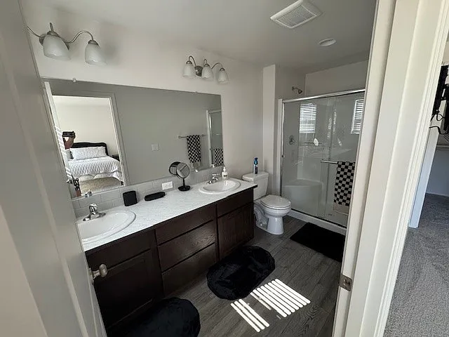 Master bath with two sinks and walk-in shower