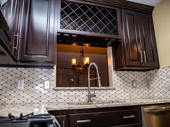 Granite countertops and large wine rack.