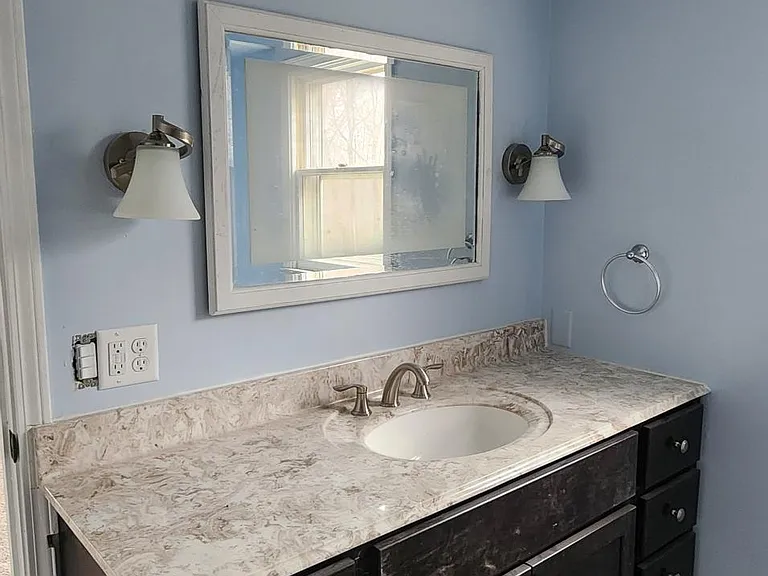 The main bedroom full completely renovated bathroom from different angle.