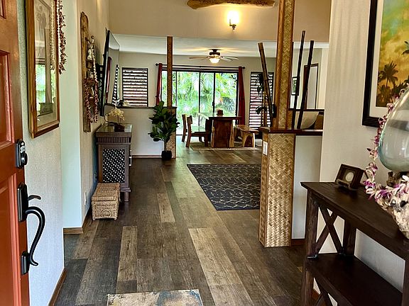 Front door opens to a beautifully furnished home with luxury vinyl plank flooring.