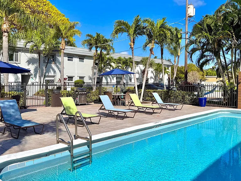 Enjoy a tranquil poolside escape with comfortable loungers and lush surroundings.
