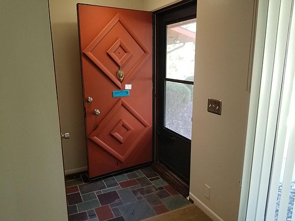 Front entryway with original slated tile. Spacious closet to left of image.