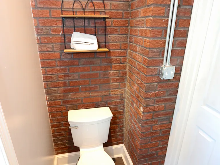 Quaint exposed brick in 1st floor bathroom