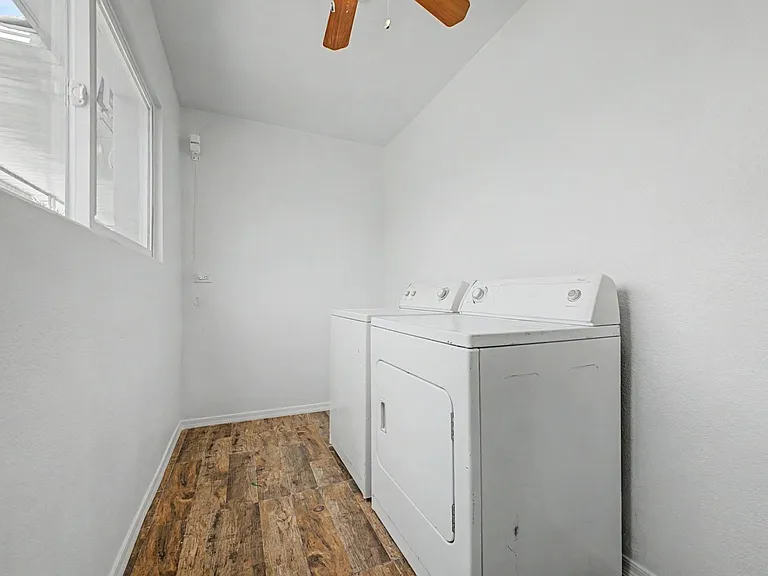 Lower Level Dedicated laundry room with side-by-side washer and dryer