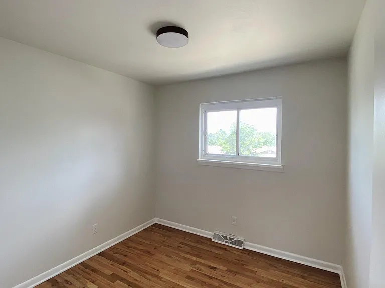 Second bedroom with a view of the front of the property.