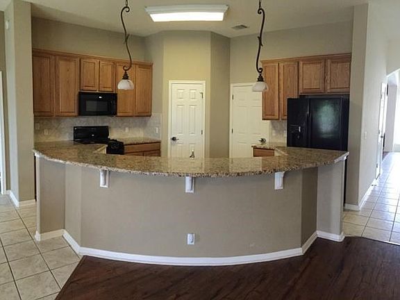 Granite countertops, circular breakfast bar, built-in appliances.  Awesome layout