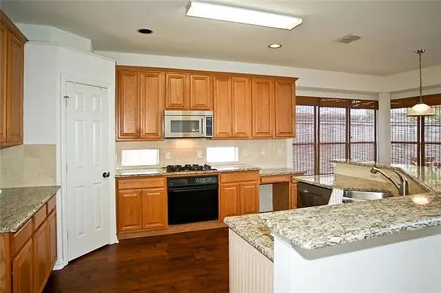 Kitchen with granite counter-tops and new gas cooktop