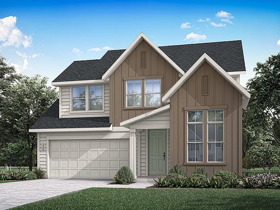 A two-story residential house with a garage, surrounded by lush greenery and a clear blue sky with f