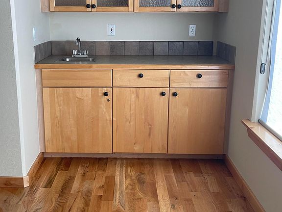 Entertainment/Bar area with storage and bar sink.