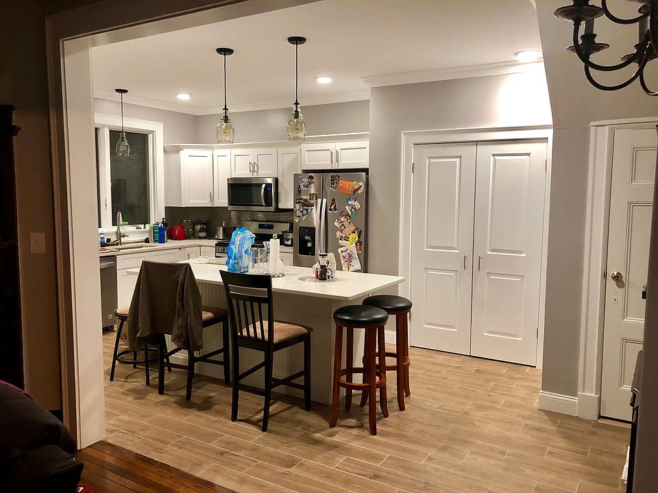 New kitchen. Quartz counters, large double door pantry. Door on right is storage and stairs to basement.