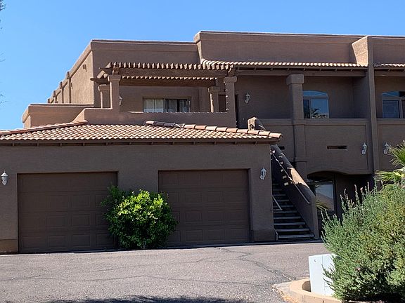 Front of unit showing garage on left and front patio.