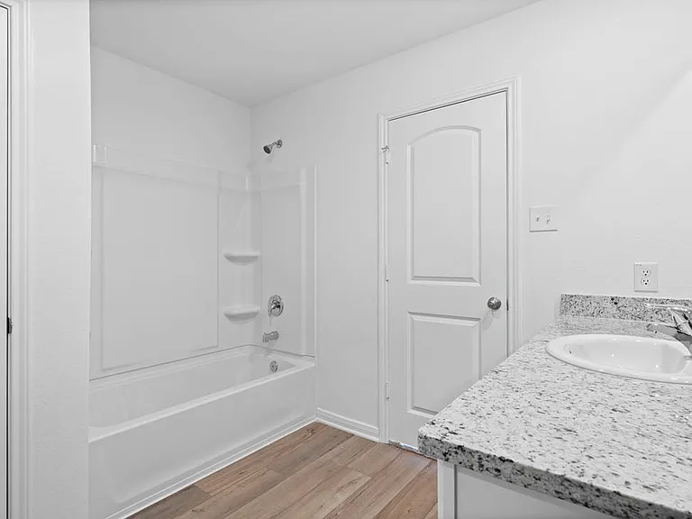 The master bathroom has a spacious vanity.