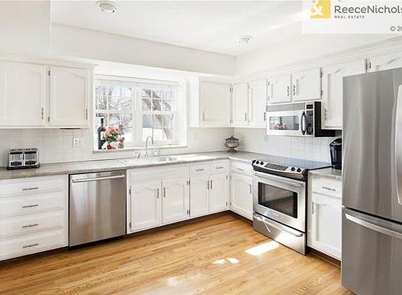 Window ledge above sink is perfect for plants.