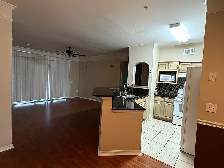Functional kitchen overlooking the living area.