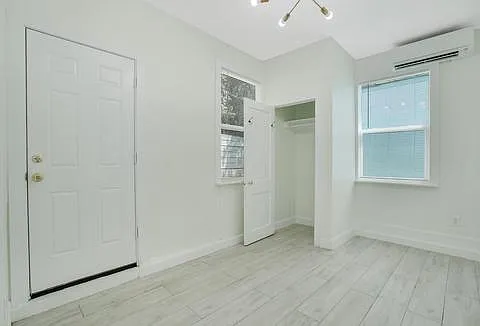 2nd Bedroom, closet door open, door out to rear yard