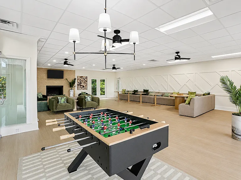 Unwind in the recreation room with games, seating, and modern decor.