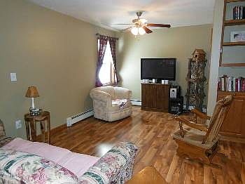 The left of the front door way is living room. The ceiling fan in the living and dining areas do a great job of cooling the home in the warm summer.