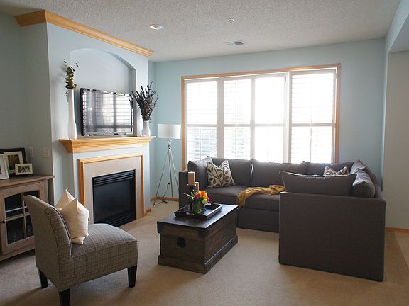 Cozy living room with fireplace and custom window coverings