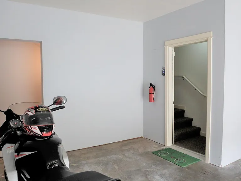 Additional storage area in garage (under steps leading to 2nd floor).