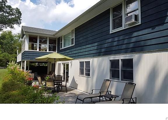 Sunny screened in porch off dining room. Patio off lower lev