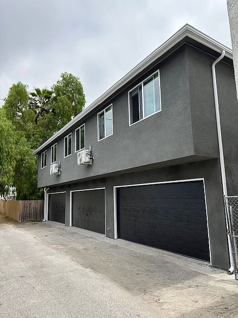 View from the alley. There are two 1 bedroom, 1 bathroom units above garages.