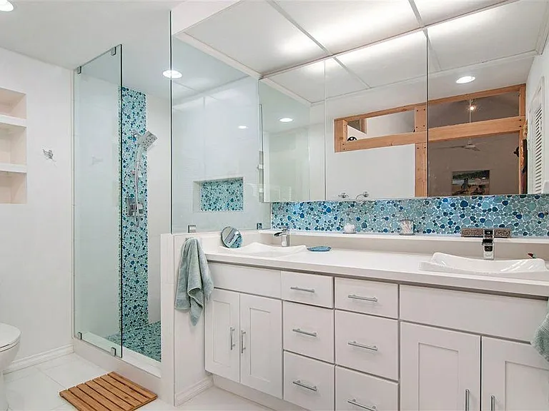 Remodel master bathroom. Seat in shower area. Double sinks.