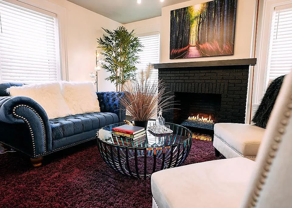 A TV is currently mounted above the fireplace, in place of the artwork shown, and will remain for tenant use.
