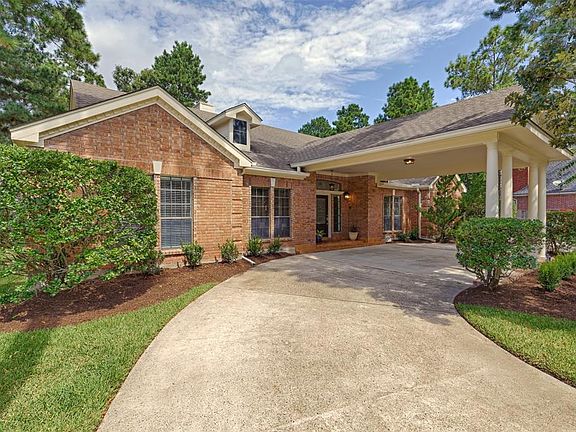 The home features a circular drive with porte-cochere for easy access to the front door. It also includes a three car detached over-sized garage plus a workshop.