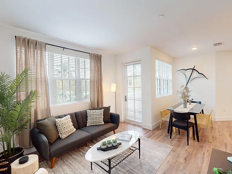 Open living space with patio access. Hurricane impact windows and doors.