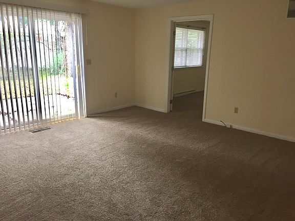 Living room with patio access and den located on the right.