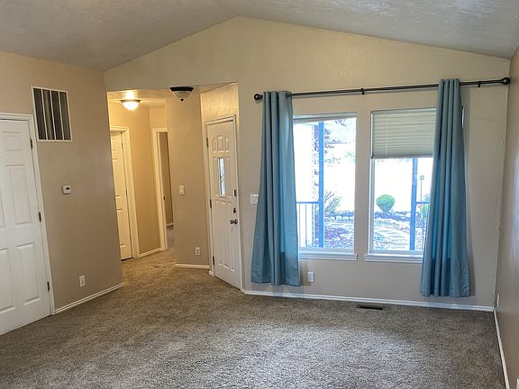 This is the living room. The small hallway on left side leads to front bedroom and small bathroom.