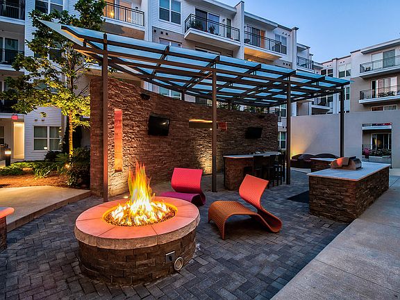 Outdoor grilling and lounge areas are located throughout the community.