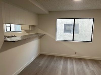 Family room with pass through from kitchen eating area. Note large window.