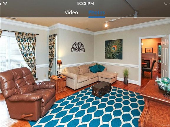 A spacious great room with crown molding and chair rail acco